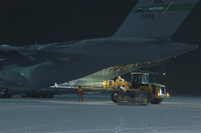 Plane being unloaded at night.