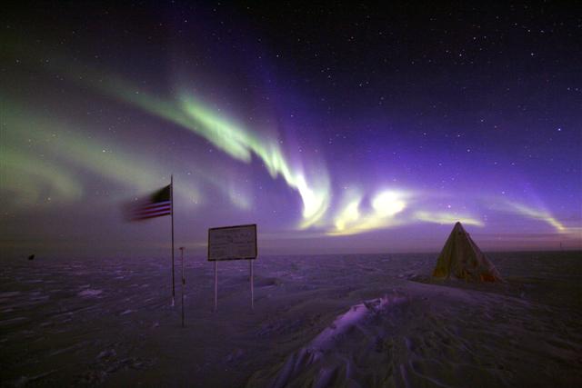 An aurora illuminates the geographic pole.