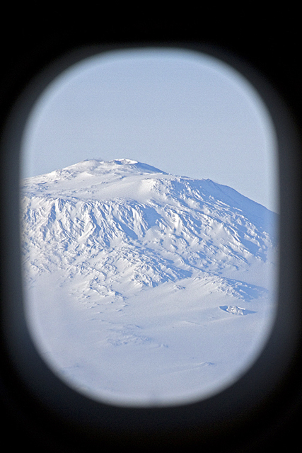 Picture of snow-covered mountain out of window.