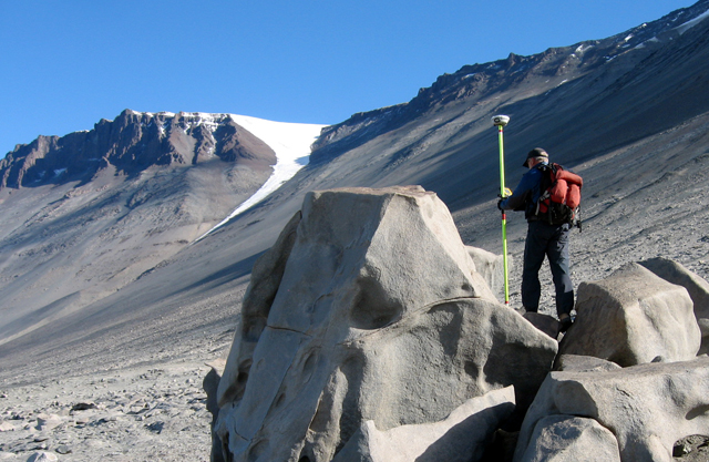 Jeff Scanniello marks a boulder using GPS.