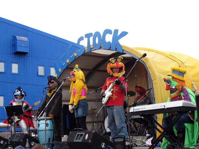 Band dressed in costumes on a stage.