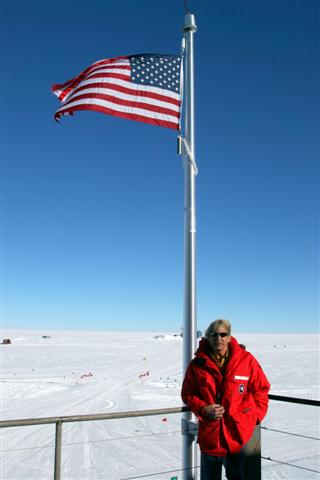 Jerry Marty stands at the flagpole of the new South Pole Station.