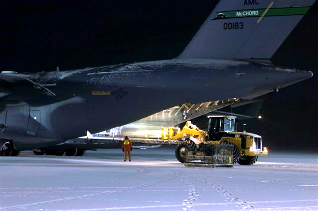 Offloading cargo from C17 at night.