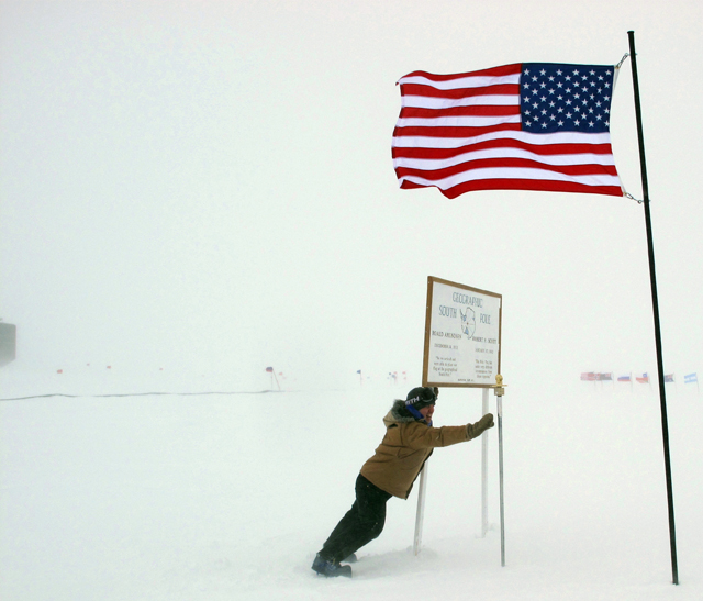 Person stands in strong wind storm.