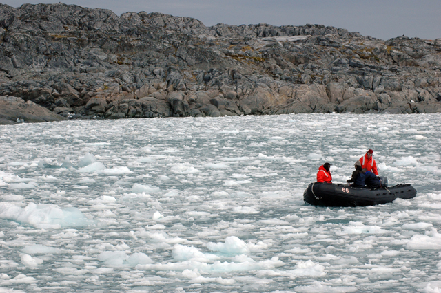 Dive boat pushes through brash ice in Hero Inlet.