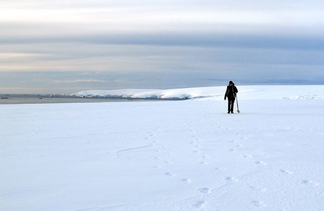 Person hikes on a glacier.