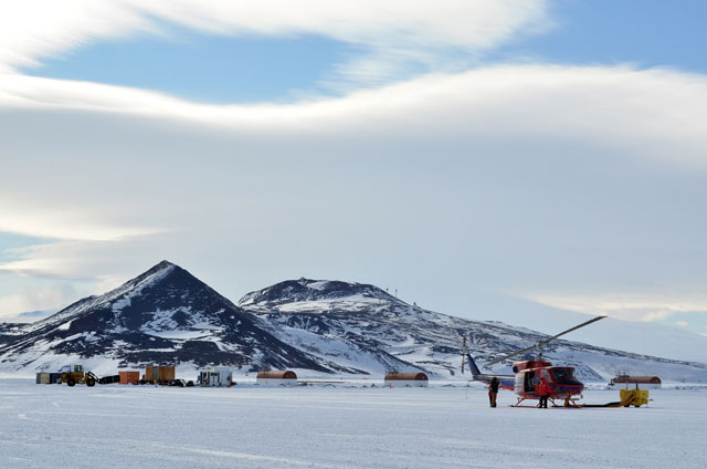Helicopter sits on ice.