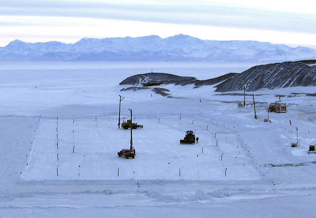 Vehicles drive around on ice.