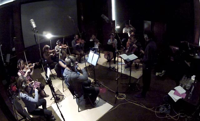 Musicians play in a studio.