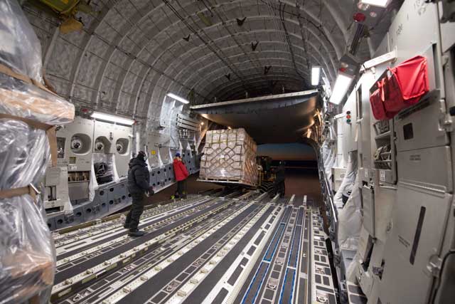 Cargo is removed from inside a plane.