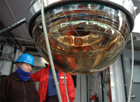 Spherical instrument with woman in background.