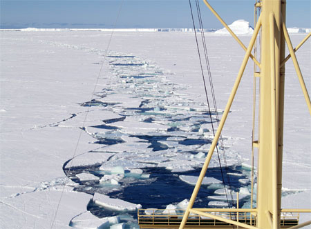 Ship breaks channel in sea ice.