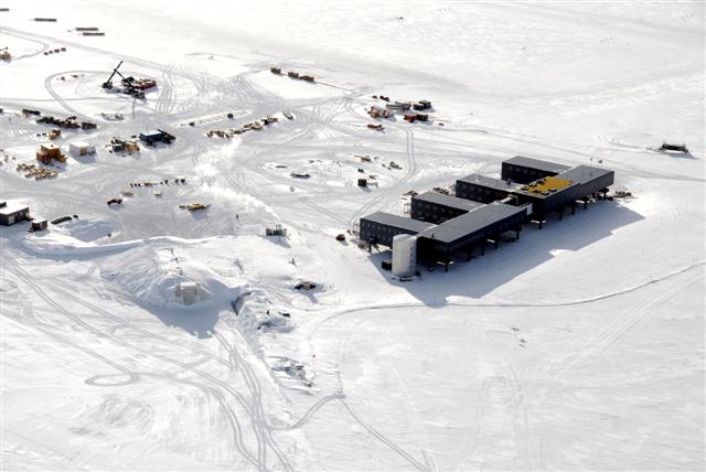 Aerial view of large building and other smaller structures.