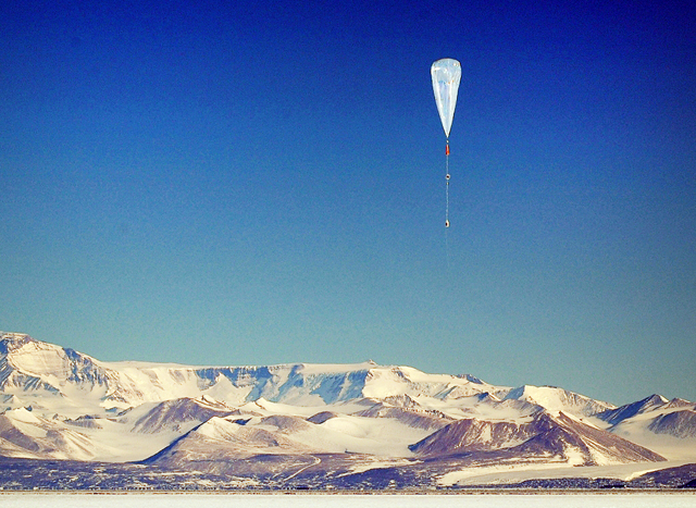 Large balloon floats above ice.