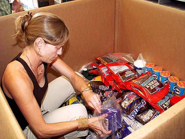 Packing snacks into a box destined for a field camp.
