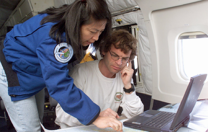 Scientists aboard plane conducting aerial survey.