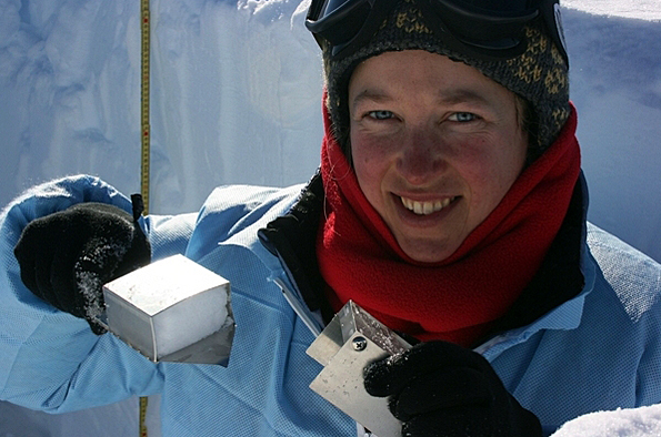 Woman holds up ice sample.