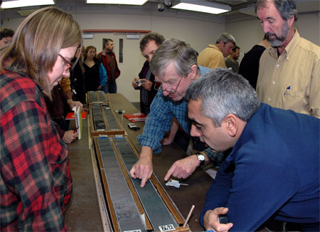 People look at sediment cores.