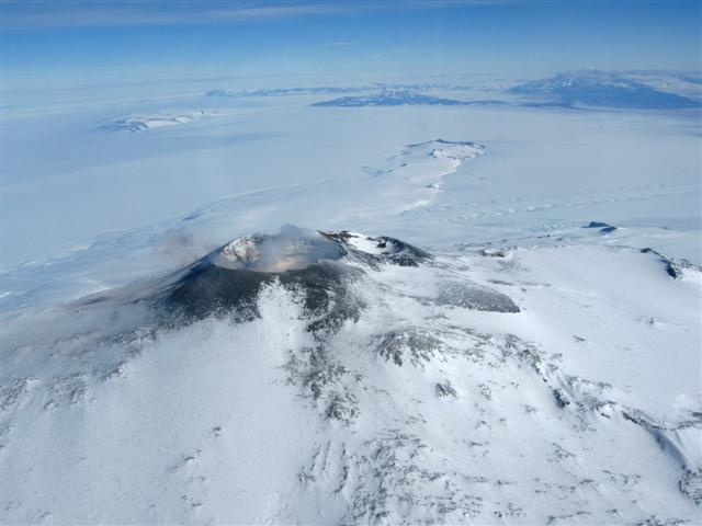 Volcano crater amid plain of ice.