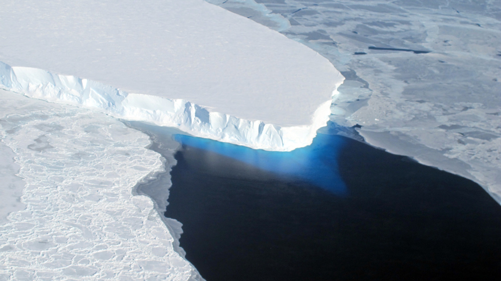 Aerial view of ice shelf and water.