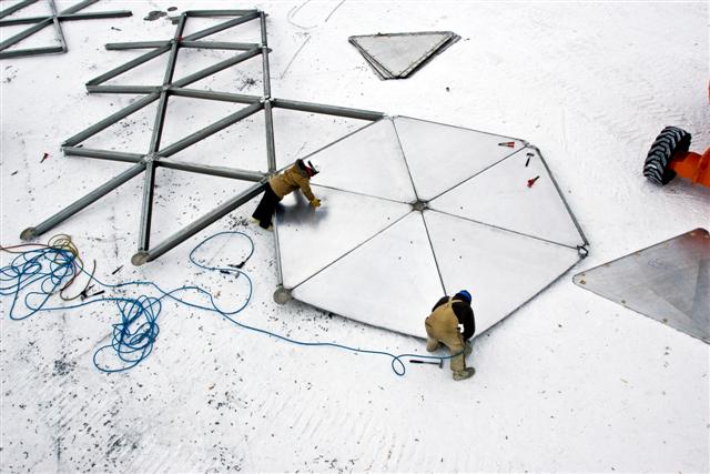 Crew disassembles dome panels.