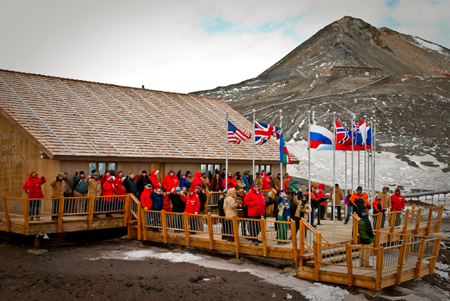 People stand on the deck of the McMurdo chalet.