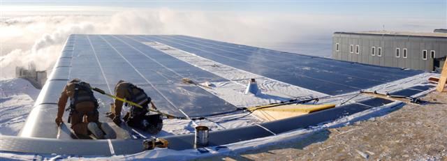 South Pole carpenters install siding on the station's roof.
