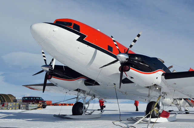 An aircraft sits on a ice-covered area.