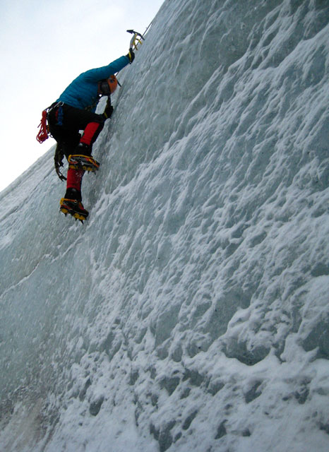 Person climbs an ice wall.