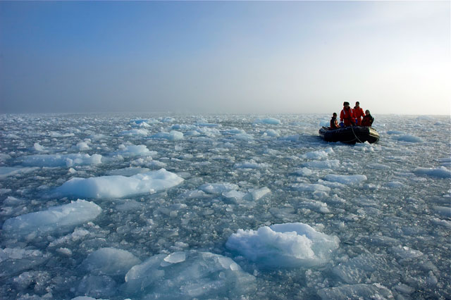 People on a boat going through ice.