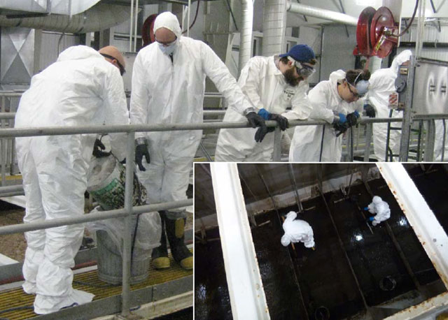People in white smocks clean facility.