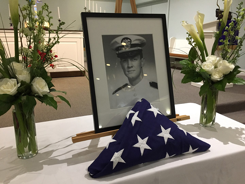 Dick Bowers's portrait and folded flag at his memorial service on March 9, 2019.