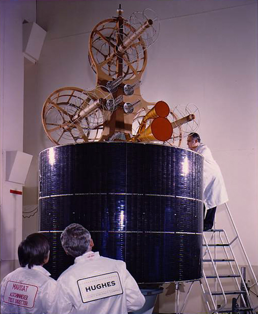 Engineers work on a Marisat satellite.