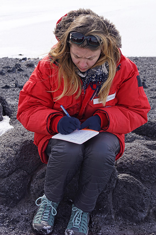 At the Cape Royds penguin colony, Scarano jots down observations in her notebook.