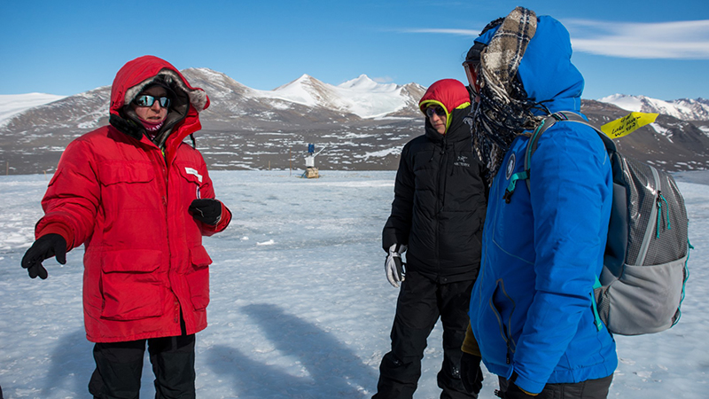 Atop the Canada Glacier, Scarano (right) interviews researchers Dorota Porazinska (left) and Pacifica Sommers.