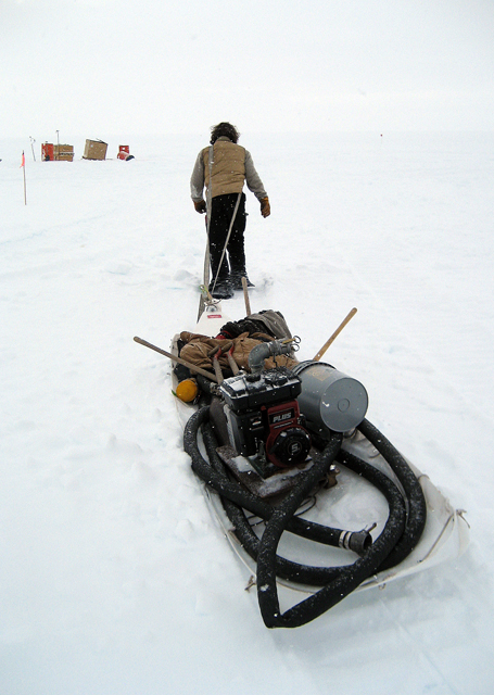 Worker pulls sled.