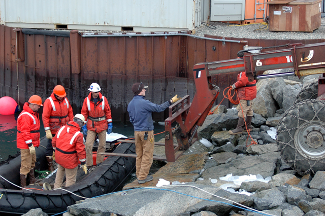 Loading cargo onto a boat.