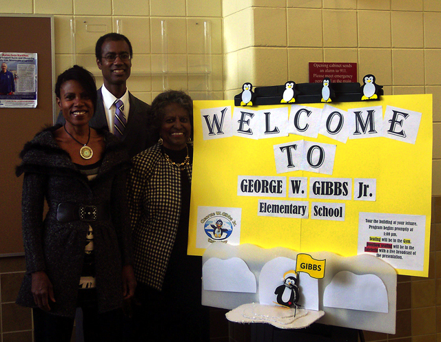 People standing near a sign.