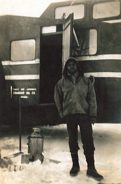 Man stands in front of vehicle.