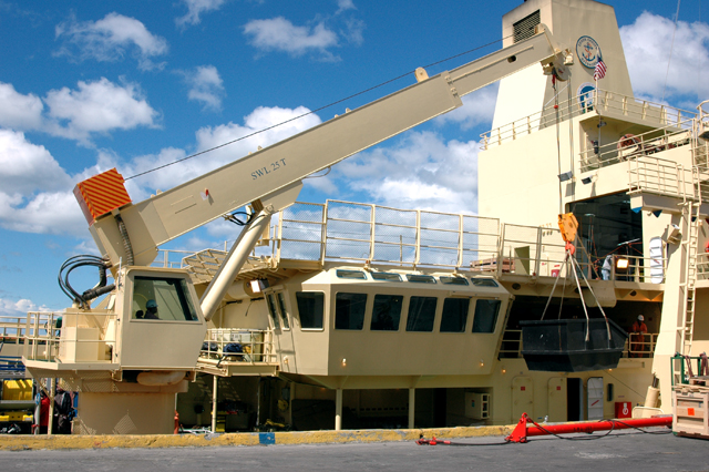 A shipboard crane moves cargo onto the Gould.