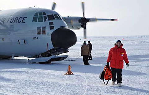 Person exits airplane on ice.
