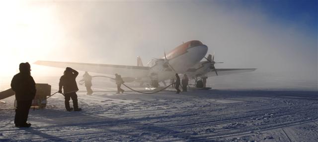 People fuel an airplane.