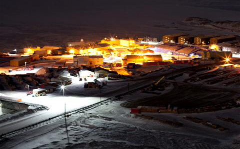 Town lit up at night.
