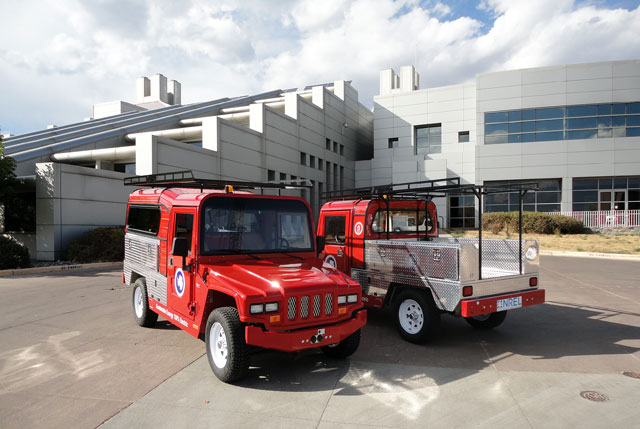 Trucks parked in front of a building.