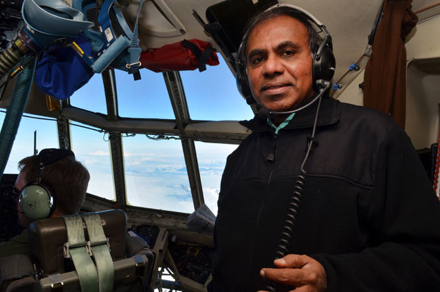 Man in cockpit of plane.