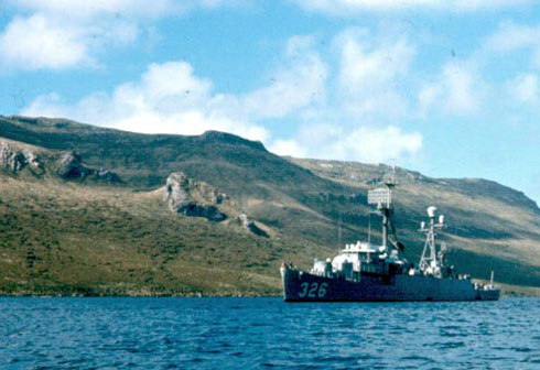 Ship anchored off an island.