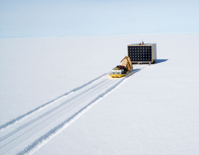 Boxy-looking robot pulls sled.