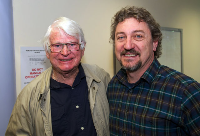 Two men pose for a photo.