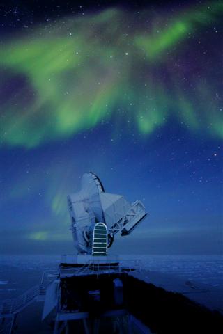 Aurora behind a telescope.
