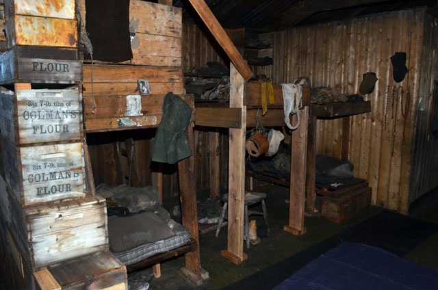 Old bunk beds near a wall of crates.